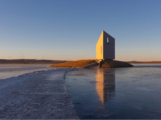 The Island — Drone pulls wide — the chapel alone on the ice